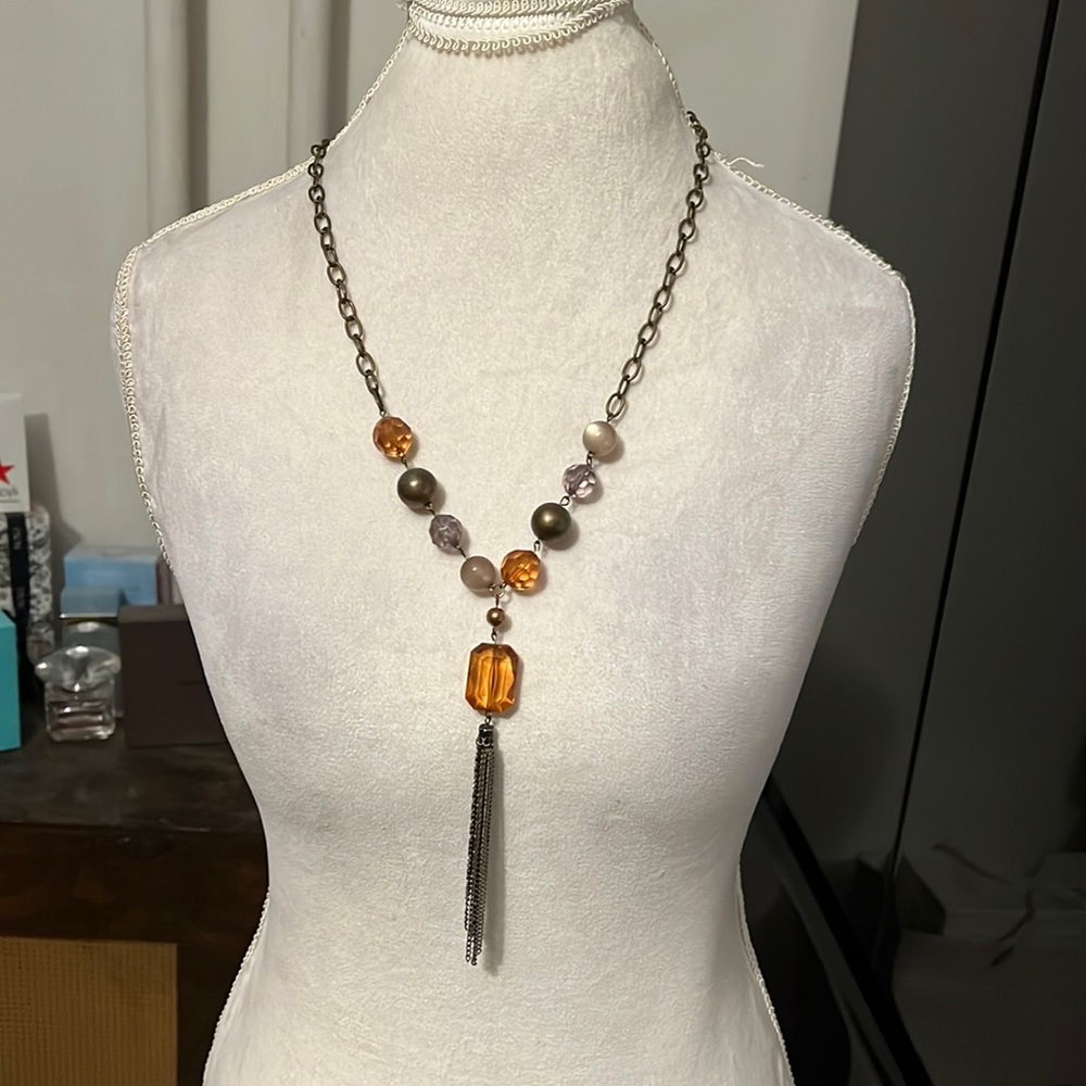 Long necklace with brown beads and a tassel